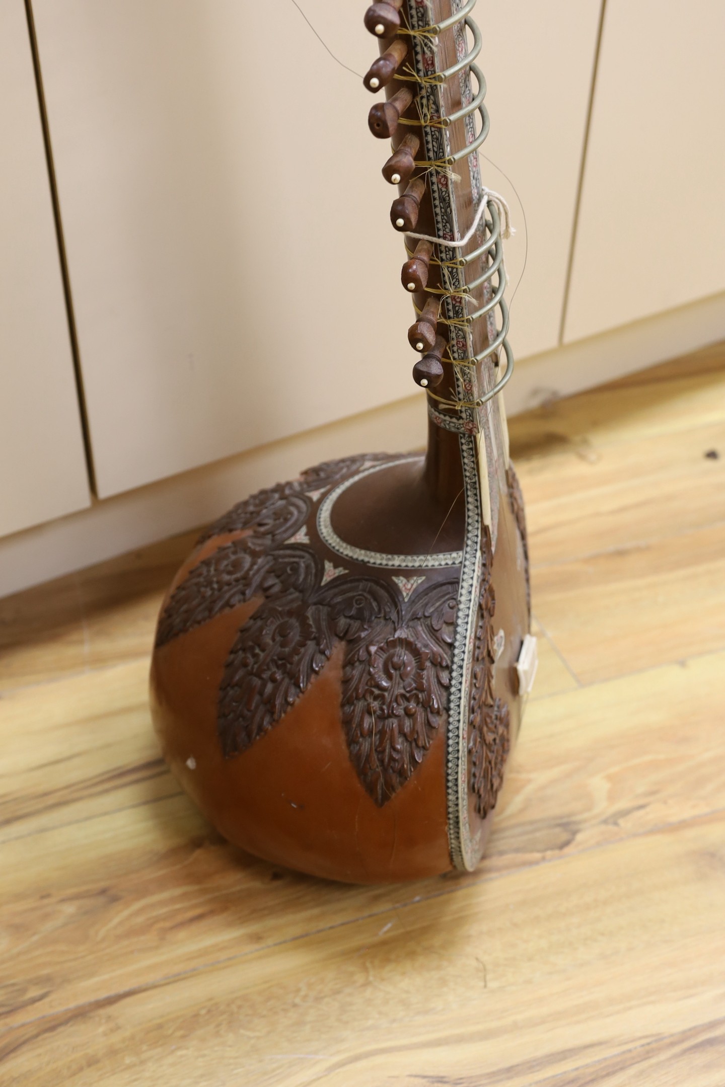 A sitar with wooden carved decoration